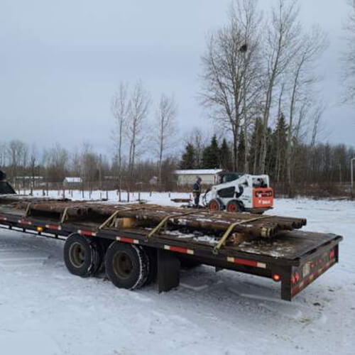 Screw Pile Extensions loaded on a flatbed trailer