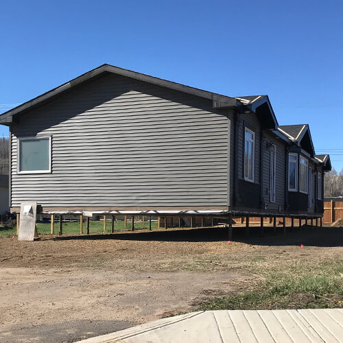 A manufactured house on a screw pile foundation system