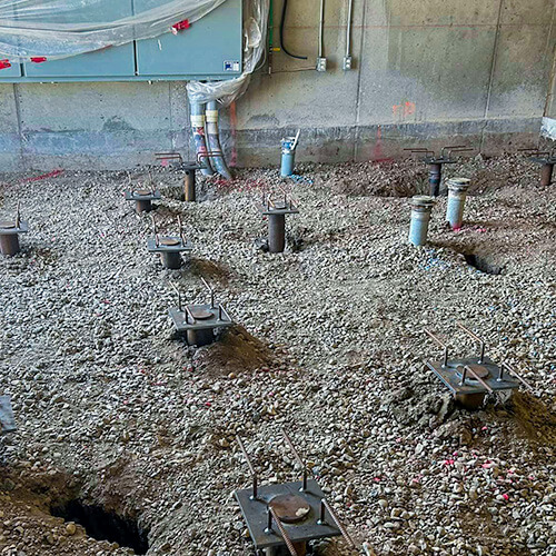 Screw Piles evenly layed out in a floor where concrete is to be poured